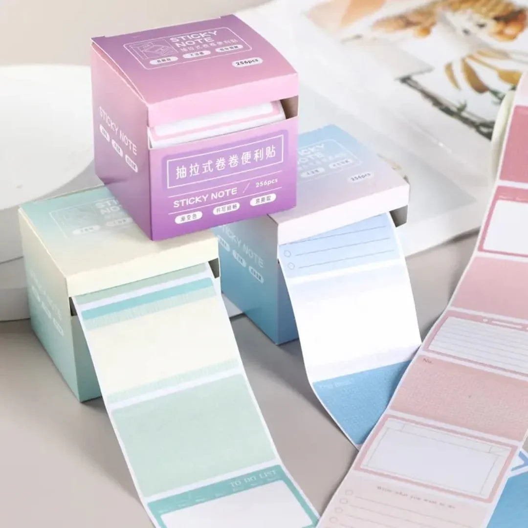 Pastel-colored sticky notes with packaging on a light surface